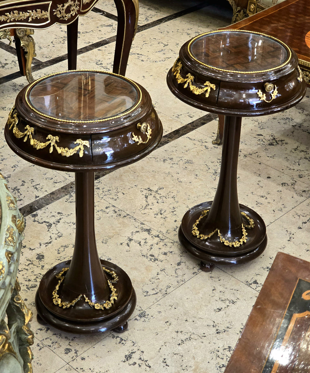 Set of 2 French Neoclassical Side Tables – Dark Wood, Glass Tops & Gold Leaf Details