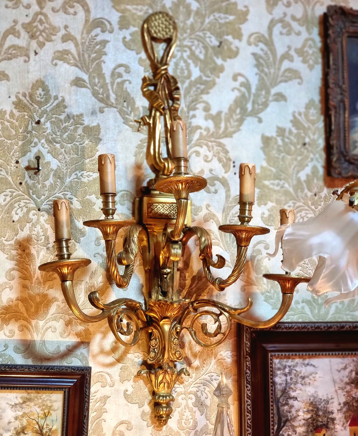 Pair of French Louis XV Style Gilded Bronze Wall Sconces with Five-Light Candelabra Arms and Elaborate Foliate Details