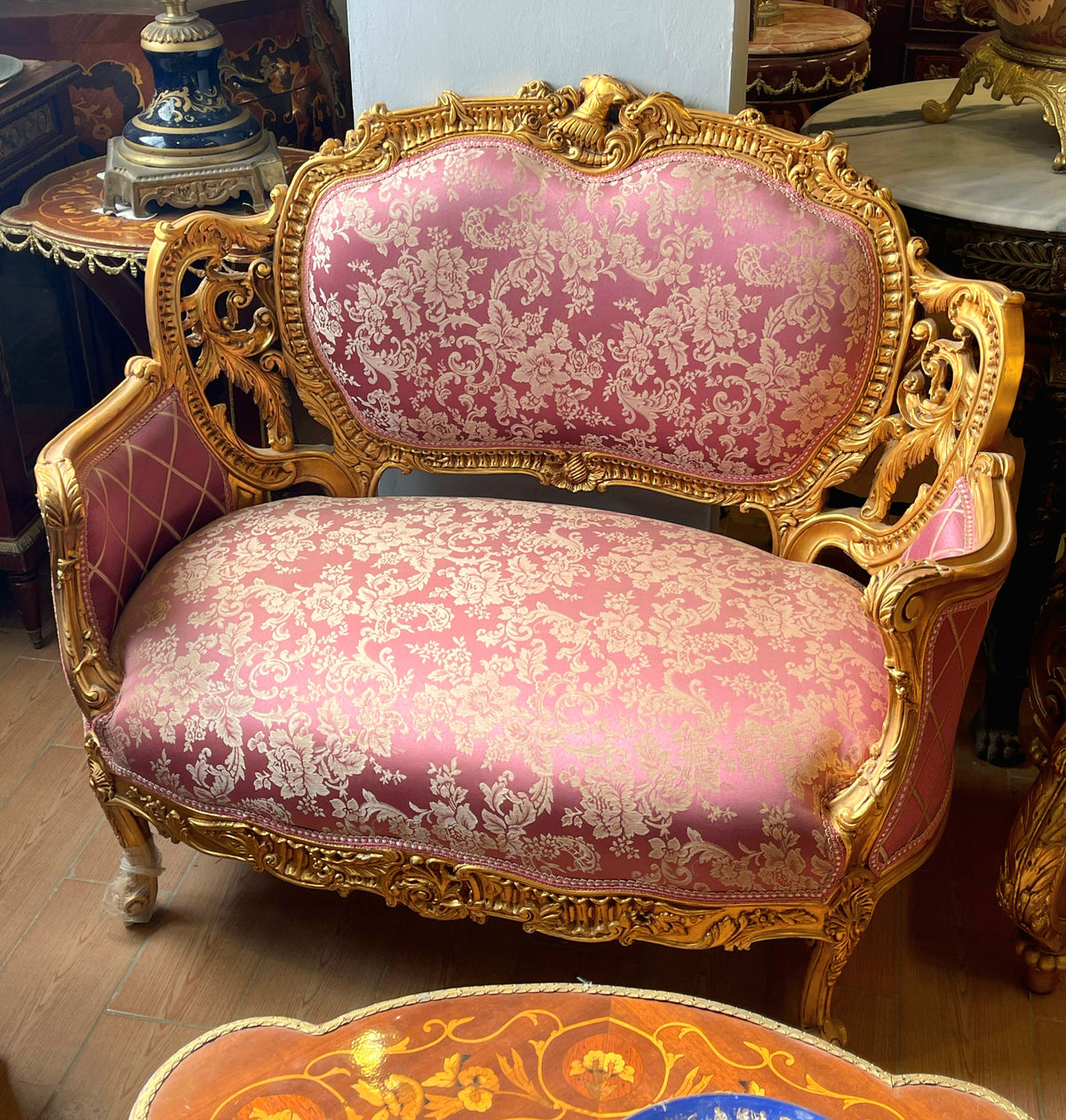 French Rococo Loveseat – Pink Damask Upholstery, Ornate Gold Leaf Frame & Carved Floral Details