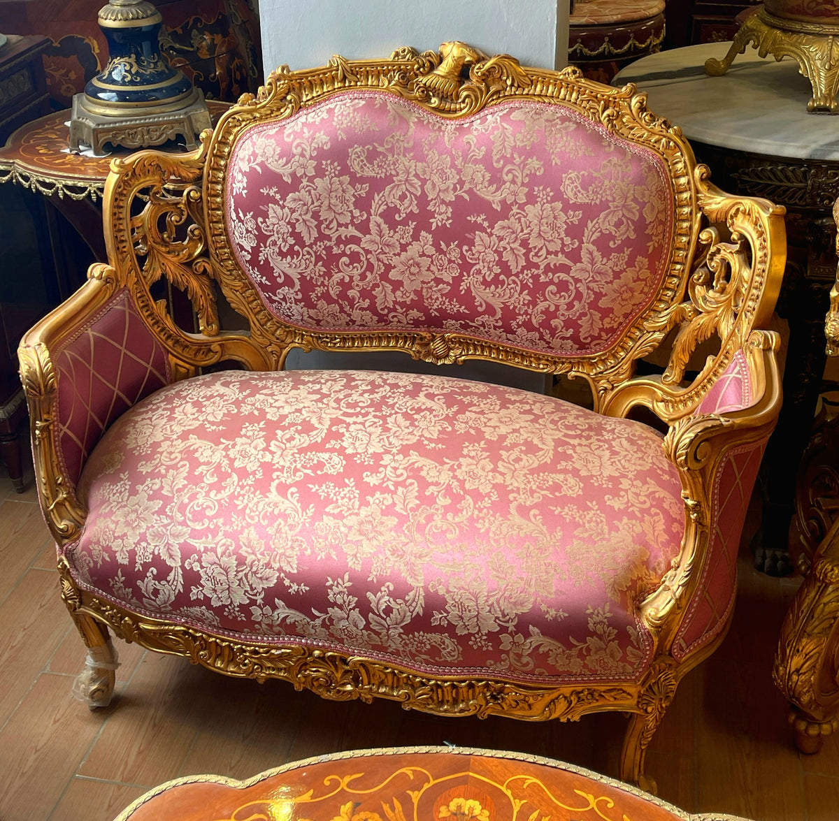 French Rococo Loveseat – Pink Damask Upholstery, Ornate Gold Leaf Frame & Carved Floral Details