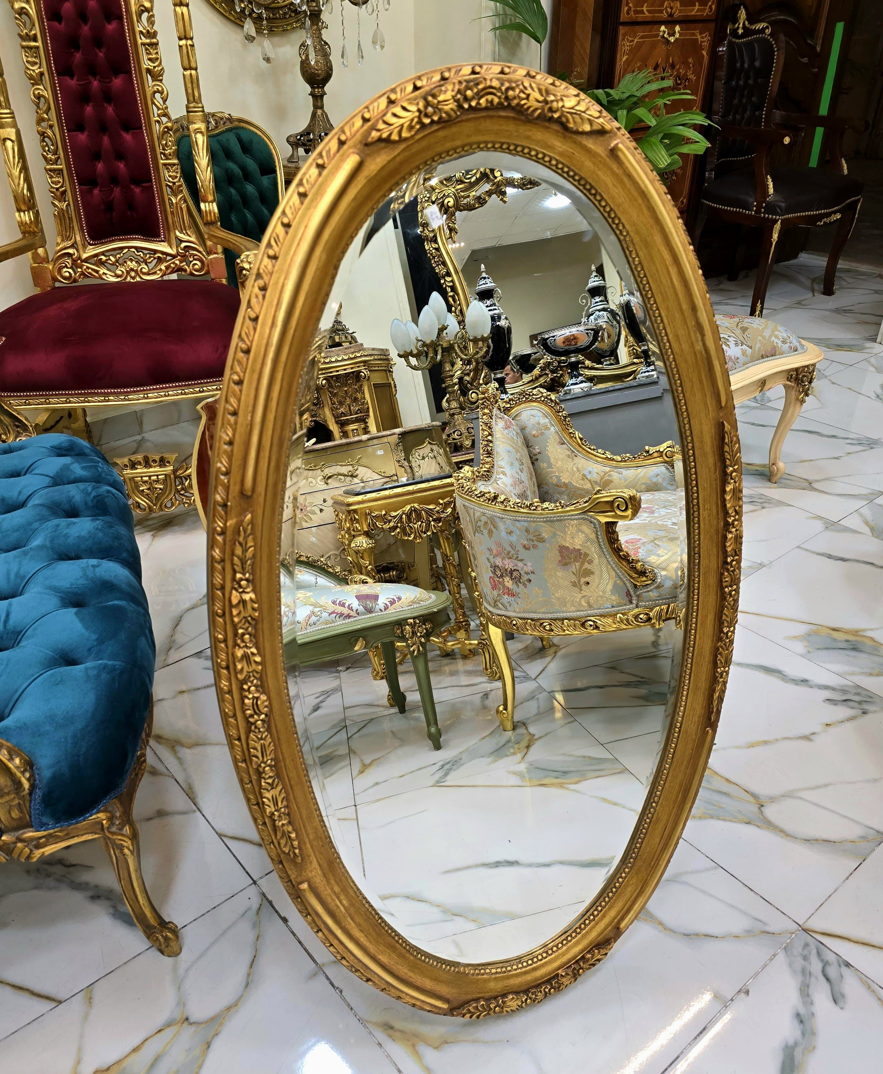 French Oval Wall Mirror with Floral Center Detail & Gold Leaf Frame