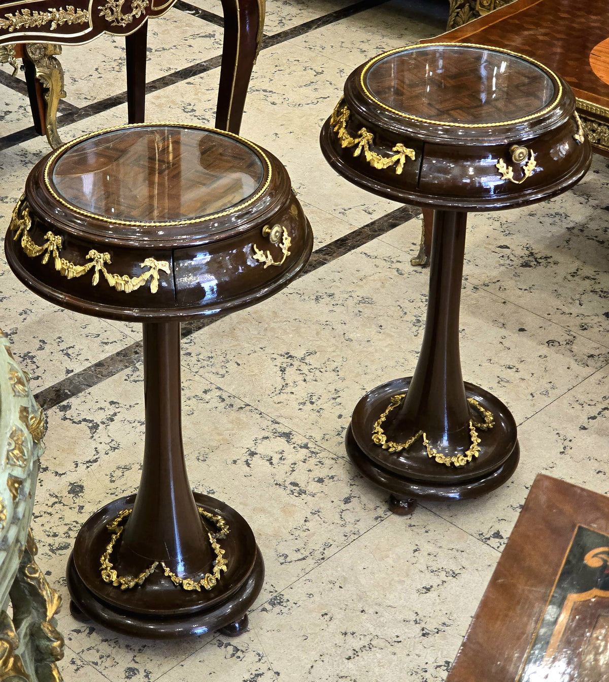 Set of 2 French Neoclassical Side Tables – Dark Wood, Glass Tops & Gold Leaf Details