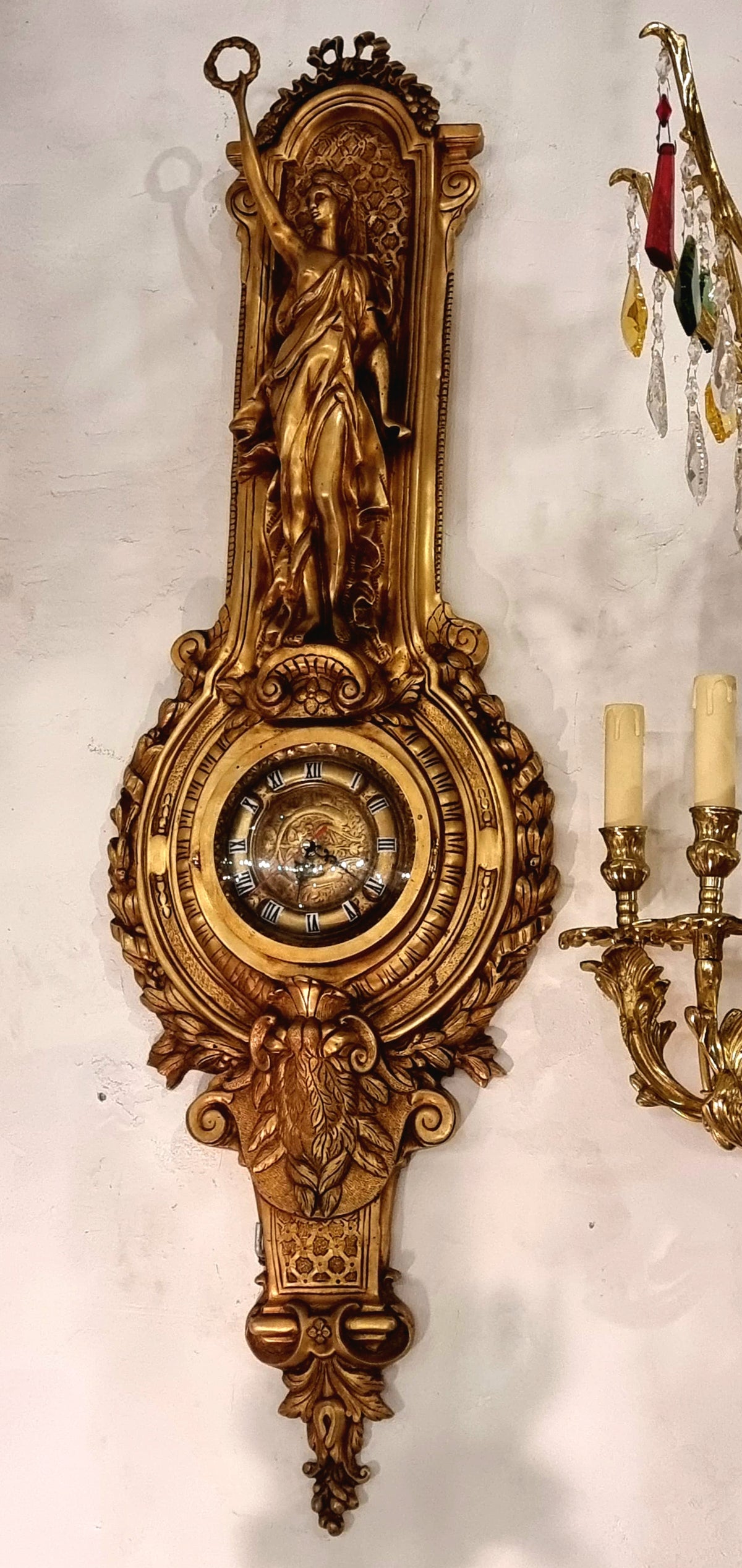French Rococo Style Gilded Bronze Wall Clock with Sculptural Female Figure, Gold Leaf and Elaborate Foliate Details