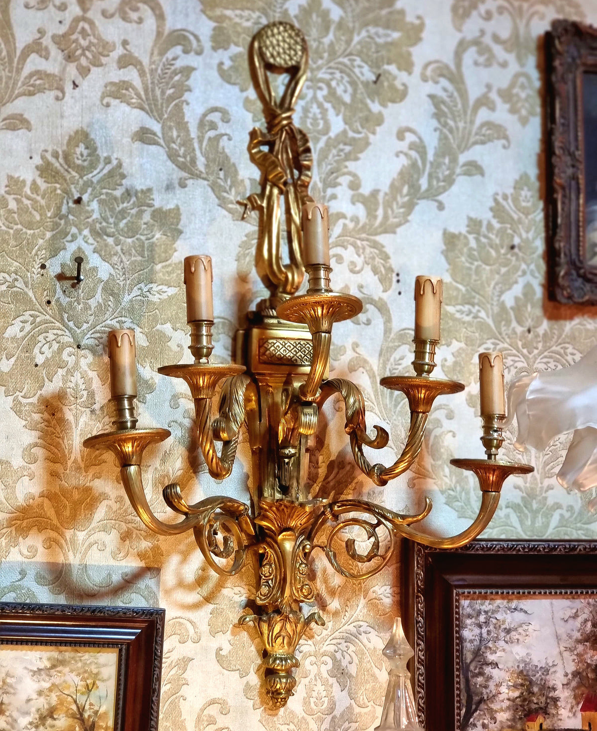 Pair of French Louis XV Style Gilded Bronze Wall Sconces with Five-Light Candelabra Arms and Elaborate Foliate Details