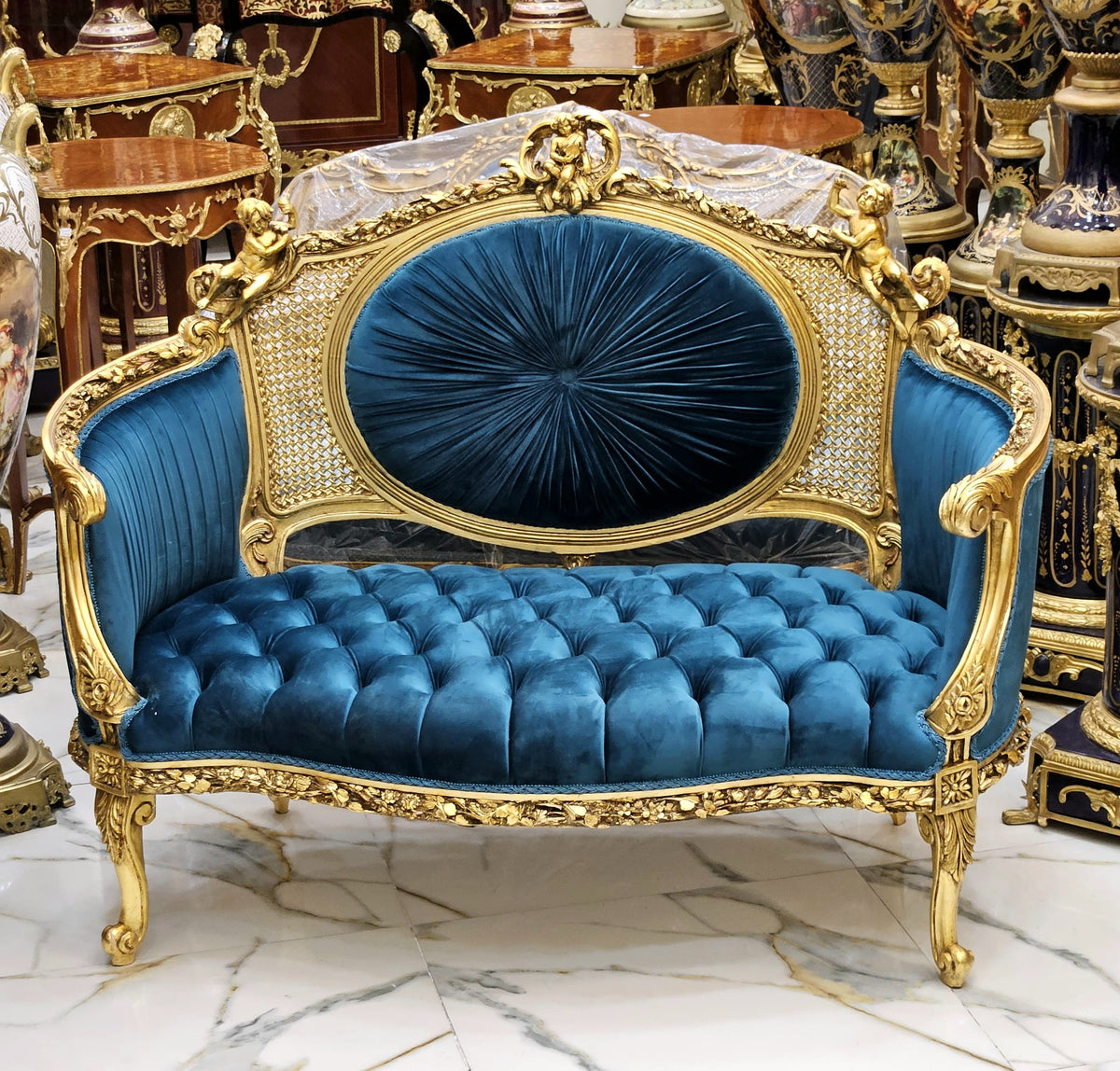 Emerald Opulence – French-Inspired Settee with Deep Green Tufted Velvet, Cane Back & Gilded Cherub Details
