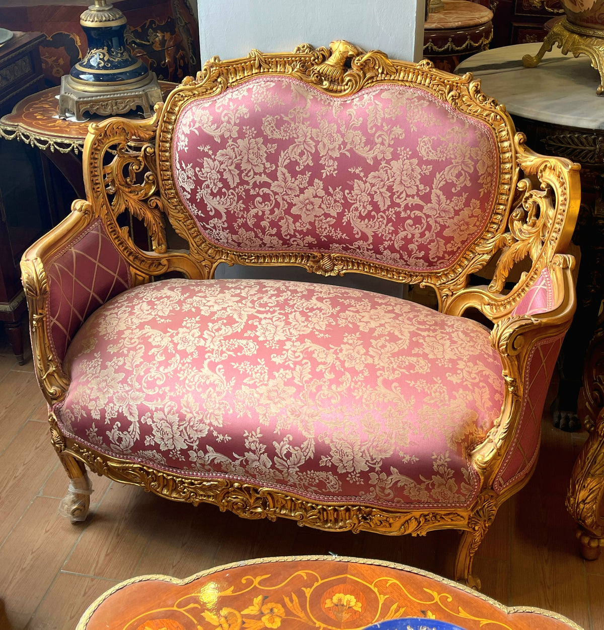 French Rococo Loveseat – Pink Damask Upholstery, Ornate Gold Leaf Frame & Carved Floral Details