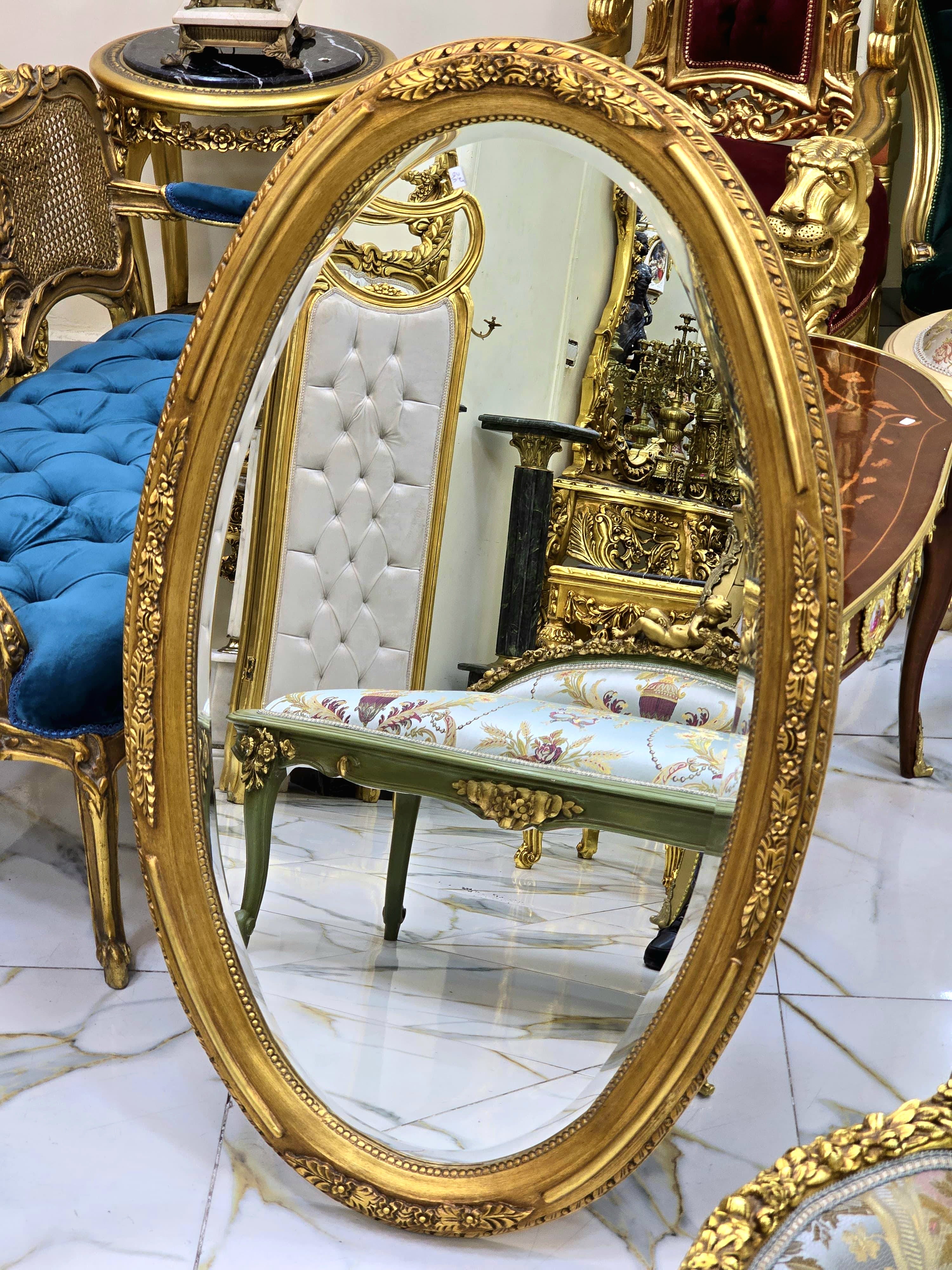 French Oval Wall Mirror with Floral Center Detail & Gold Leaf Frame
